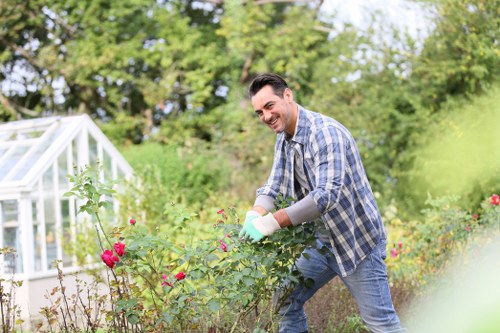 Garden operative wearing PPE and training in equipment use
